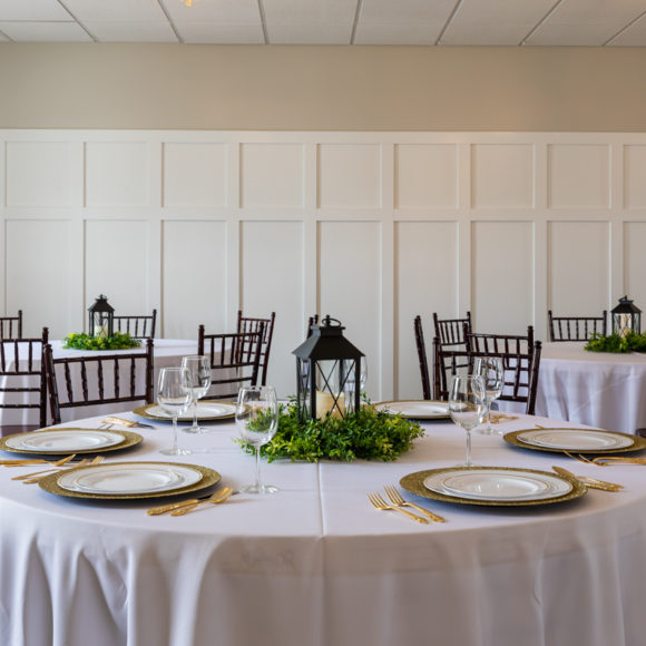 Dining room at Arbor Manor with tables decorated with table cloths and center pieces